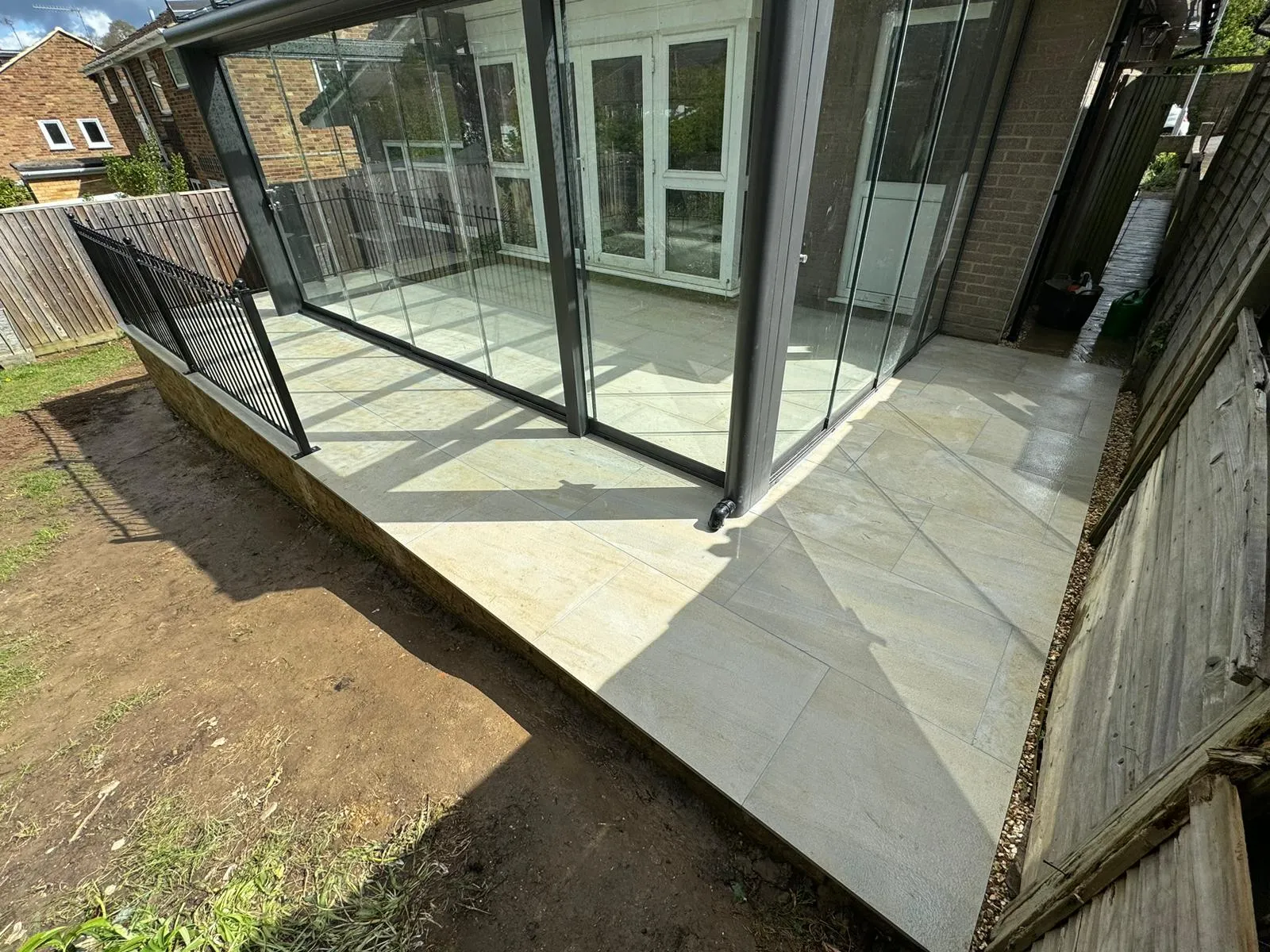 A glass enclosed patio with a sliding glass door.